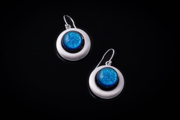 Bright blue dichroic glass circles in double silver plated settings. About one inch in diameter.